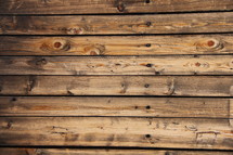 Wooden planks siding a log cabin