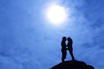 silhouette of a couple hugging 