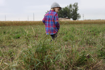 a child walking on farmland 