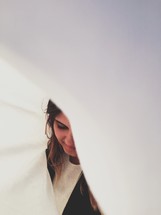 a woman under a white sheet 