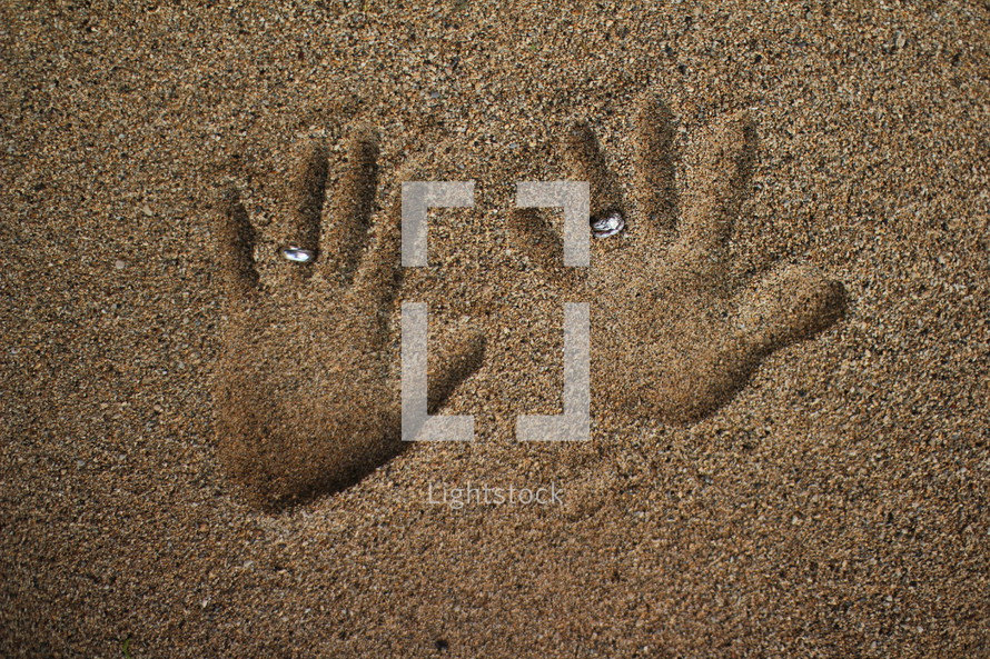 handprints in the sand