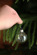 hanging a Christmas ornament 