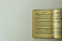 Open hymnal pages on a white background 