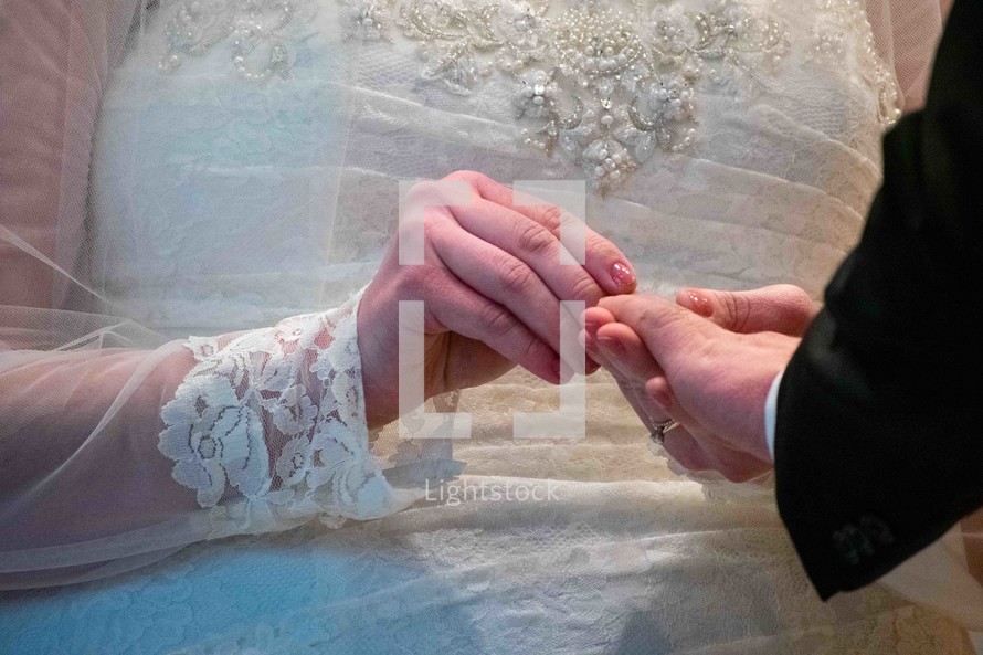 bride and groom exchanging wedding rings 