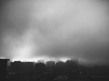 Dense fog and thick clouds over a city
