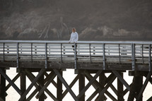 a woman standing on a pier 