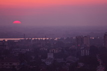 Sunset over Yangon city with the Yangon river in the distance.