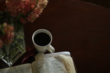 coffee mug and open Bible 