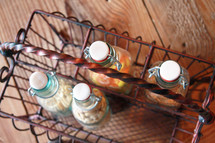 glass bottles in a metal basket