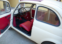 Florence, Italy - January 12, 2012: Fiat 500 was one of the most produced European cars. Side view with open door.