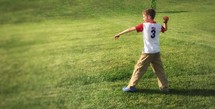a boy throwing a ball 