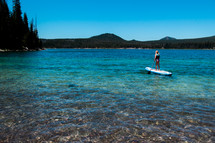 paddling on a paddle board in a lake 