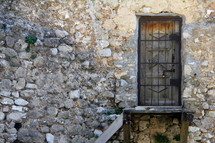 barred door and stone wall 