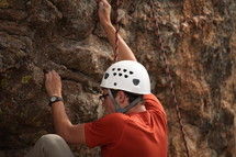 man rock climbing