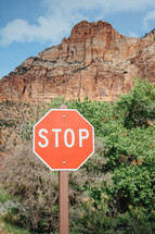red rock peak and stop sign 