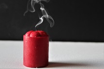 smoke from a red candle 
