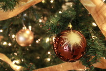 gold and red ornament on a Christmas tree 