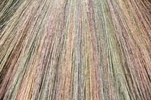 Stands of grass from a colorful handmade Pilipino sweeping brush/broom
