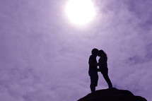 silhouette of a man and woman hugging