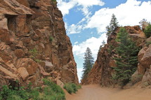 trail through red rock face cliffs