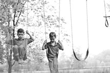 boys on a swing set 