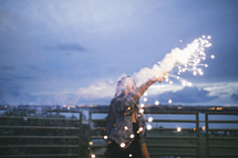 a woman holding a sparkler 