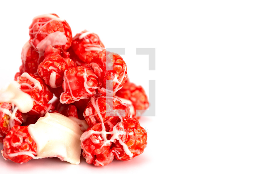 Candy Cane White Chocolate Drizzled Red Popcorn on a White Background