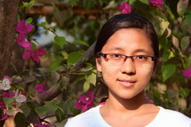 a smiling girl child with reading glasses 
