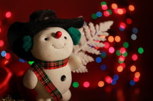 snowman figurine and bokeh Christmas lights 