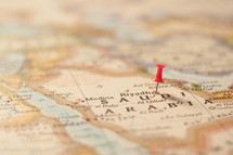 thumbtack on a map of Saudi Arabia 
