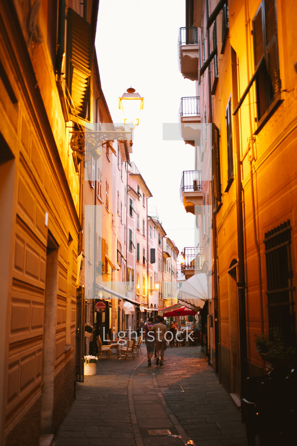 a narrow alley with cafes in Italy 