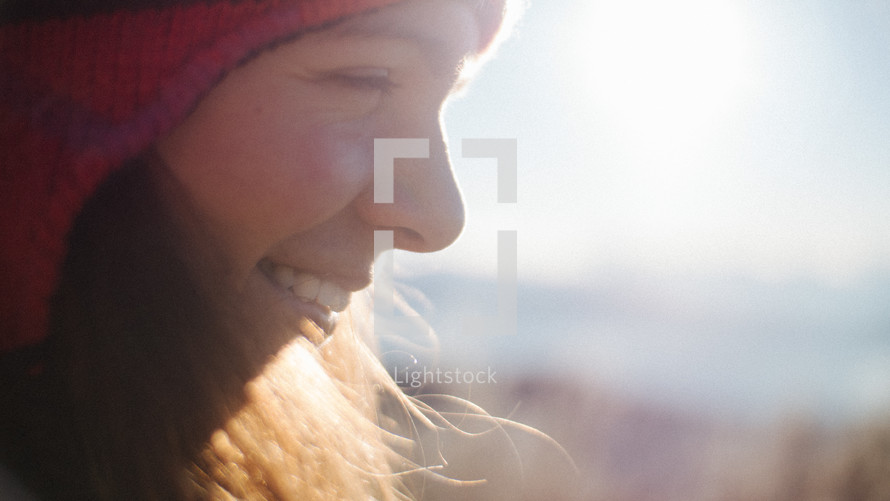smiling woman wearing a beanie 