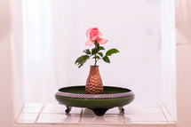 single pink rose in a vase 