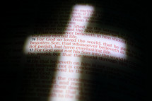 illuminated cross on the pages of a Bible, John 3:16