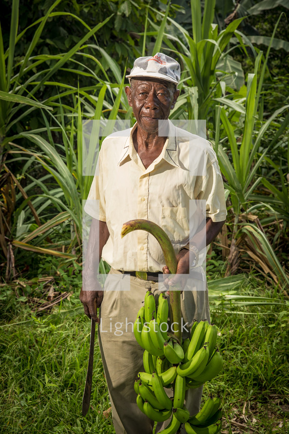 a man holding a machete and bananas 