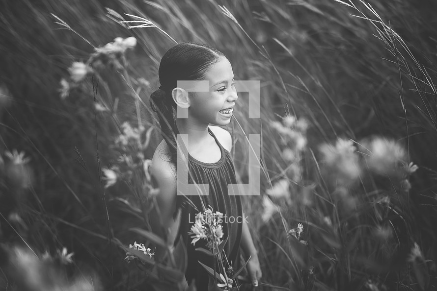 girl in a field of tall grasses 