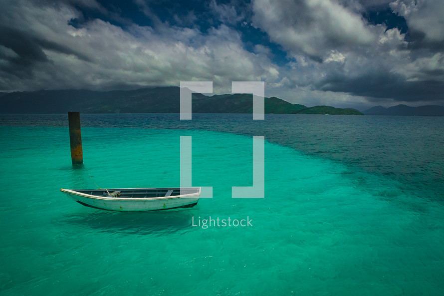 boat floating on turquoise water
