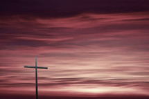 cross against a purple sky at sunset 