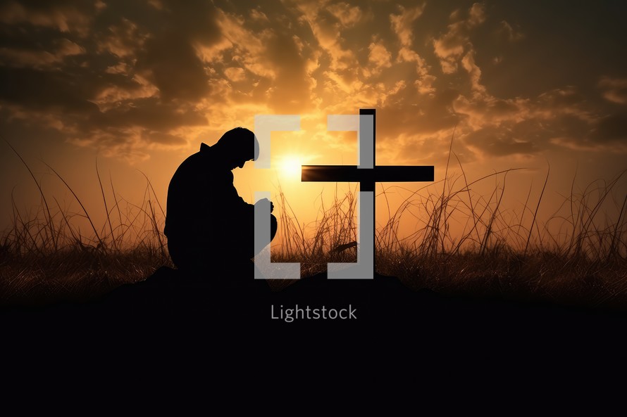 Silhouette of a man praying with a cross in the background
