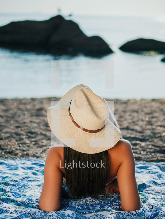 Woman In Hat Lying on sea beach