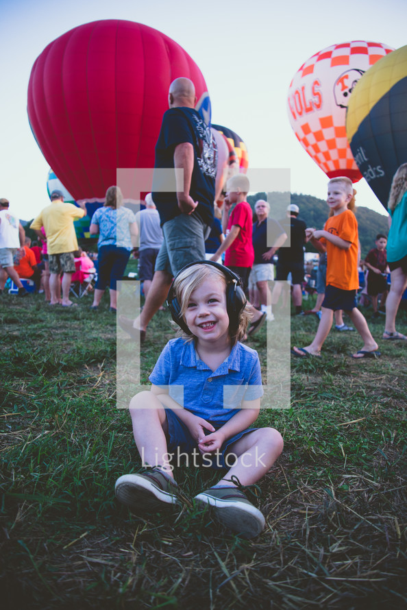 happy child at a hot air balloon festival 