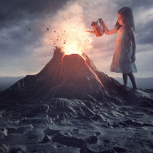 A little girl stands above a volcano and pours water to put out the flames