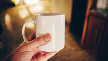 a man holding a coffee mug 