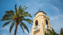church bell tower and palm tree 