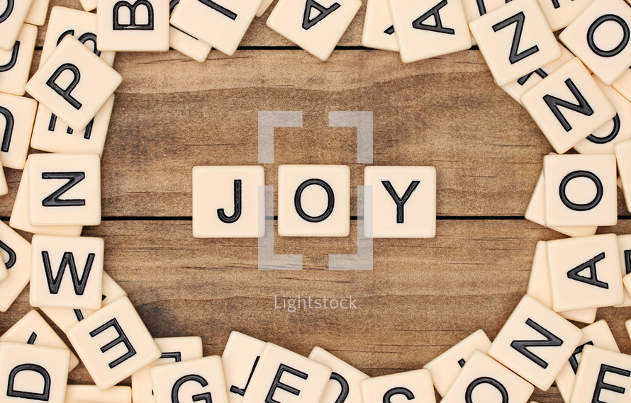 scrabble pieces and the word joy 