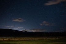 clouds in a night sky over a rural landscape 