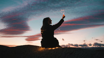 Girl at sunset Holding A Heart Symbol