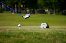 a driver and golf ball on a tee 