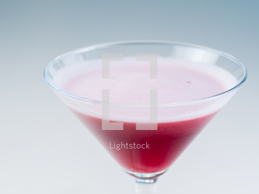 Colorful bright cocktail in a martini glass
