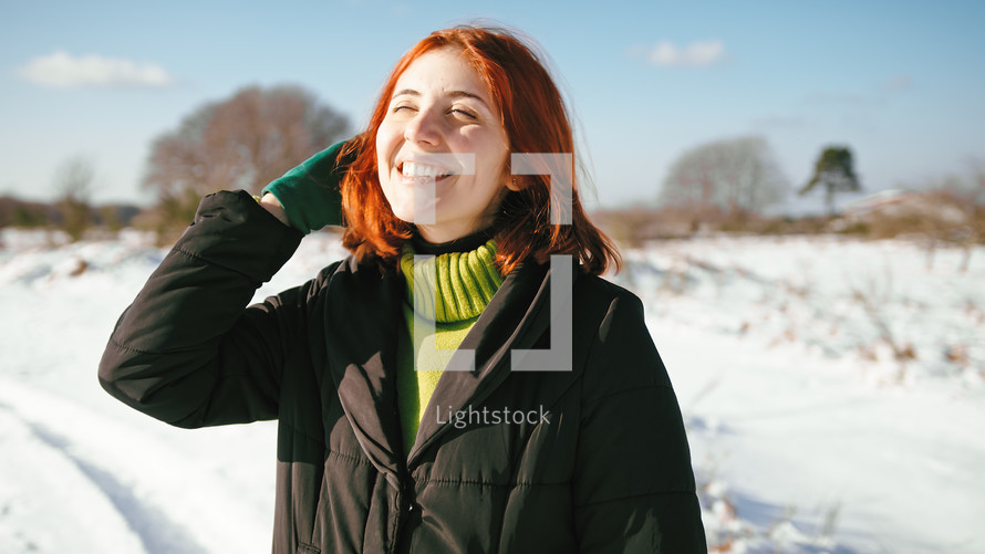 Woman kissed from the sun in the snowy mountain